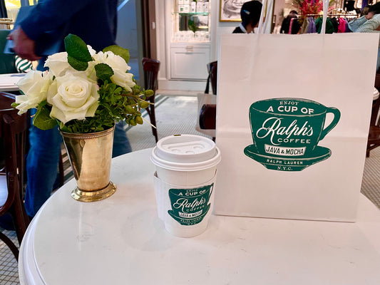 ralph lauren cafe coffee cup and shopping bag with table of flowers